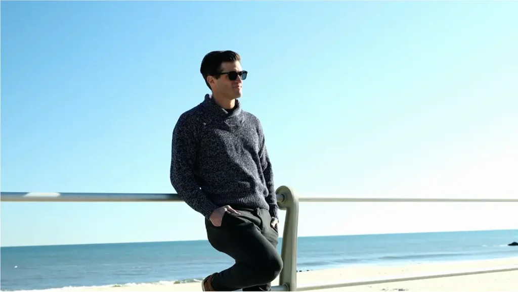 A Man Wearing Sunglasses And A Sweater