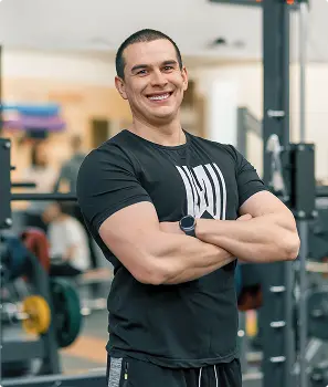 Portrait Of Muscular Sporty Smiling Man In The Gym