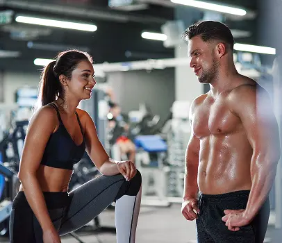 Smiling Man And Woman Talking At The Gym